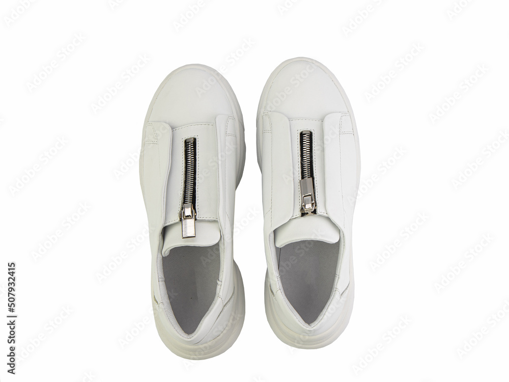 White leather sneakers with zipper in front instead of laces on white background. Casual women's style.Top view. Fashion shoes