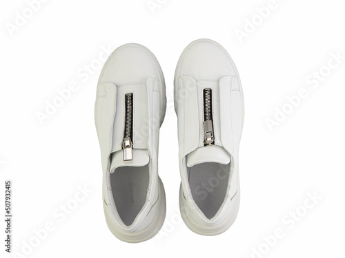 Obraz na płótnie White leather sneakers with zipper in front instead of laces on white background. Casual women's style.Top view. Fashion shoes w salonie