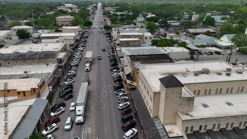 Aerial Fredericksburg Texas main street business traffic. Settled 1846 by German immigrants to south Texas. Historic homes and businesses. Tourism for crafts, dining and family exploration.
