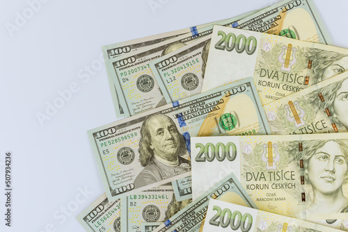 Czech korunas CZK banknotes money and American hundred dollar currency