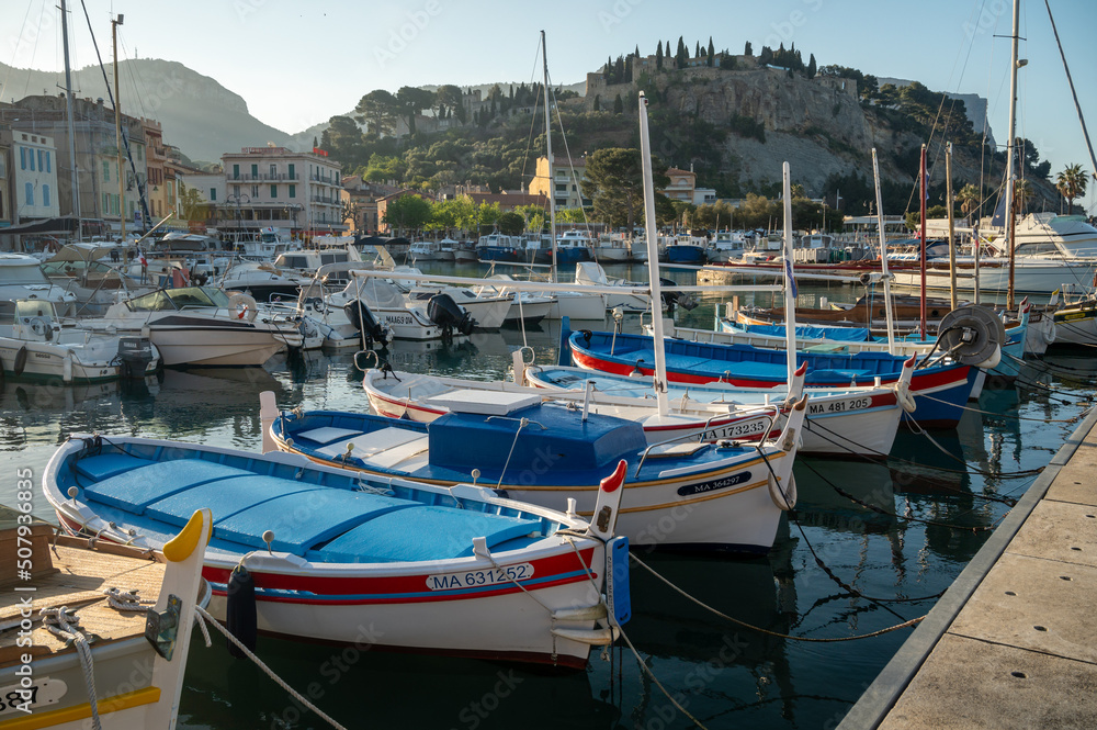 Sunny day in South of France, view on old fisherman's port with boats and colorful buildings in Cassis, Provence, France