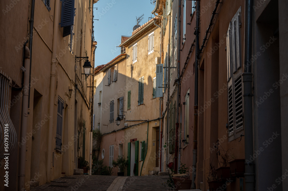 Sunny day in South of France, walking in ancient Provencal coastal town Cassis, narrow streets and colorful buildings, Provence, France