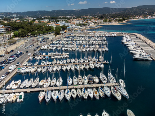 Panoramic aerial view on historical coastal Provencal city La Ciotat with large sailboat harbour and yacht shipyard, summer vacation in Provence, France