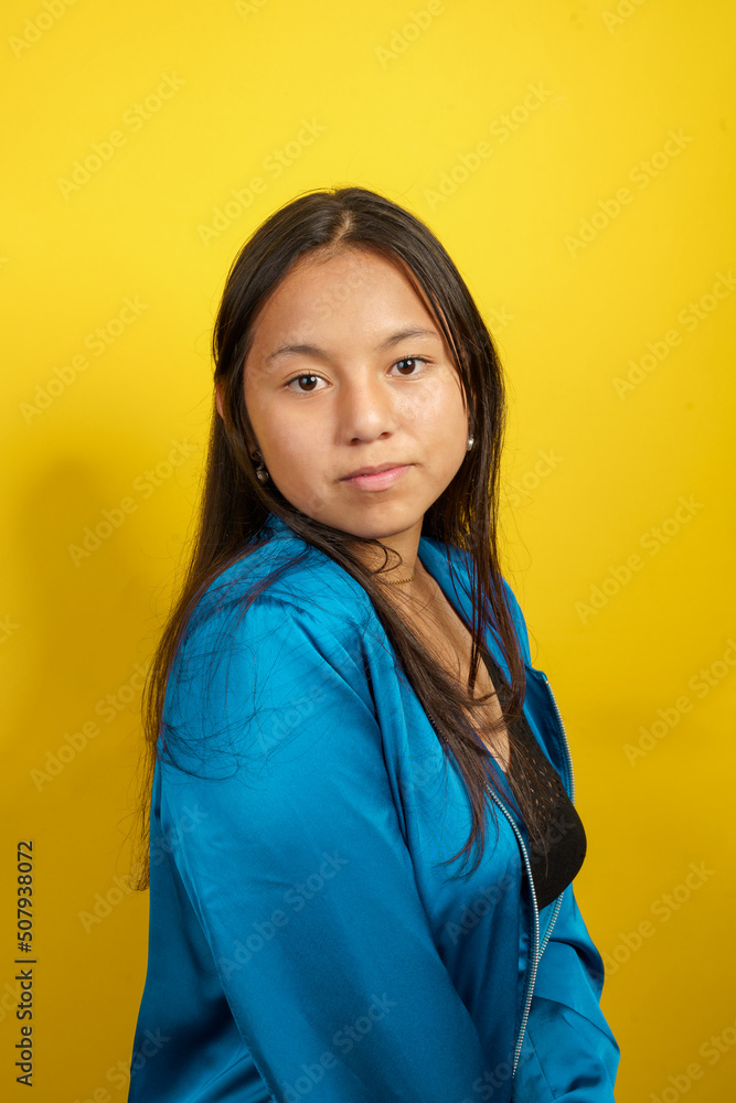 portrait of young latin woman with long black hair, natural beauty in studio with colorful background portrait of young latin woman with long black hair, natural beauty in studio with colorful background