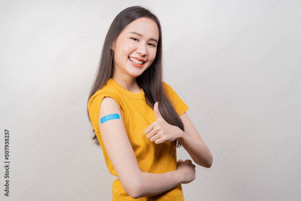 Portrait of pretty, beautiful asian young, teenage attractive after getting, receive anti virus vaccine covid-19. Showing arm on white bandage isolated on white background, copy space. Portrait of pretty, beautiful asian young, teenage attractive after getting, receive anti virus vaccine covid-19. Showing arm on white bandage isolated on white background, copy space.