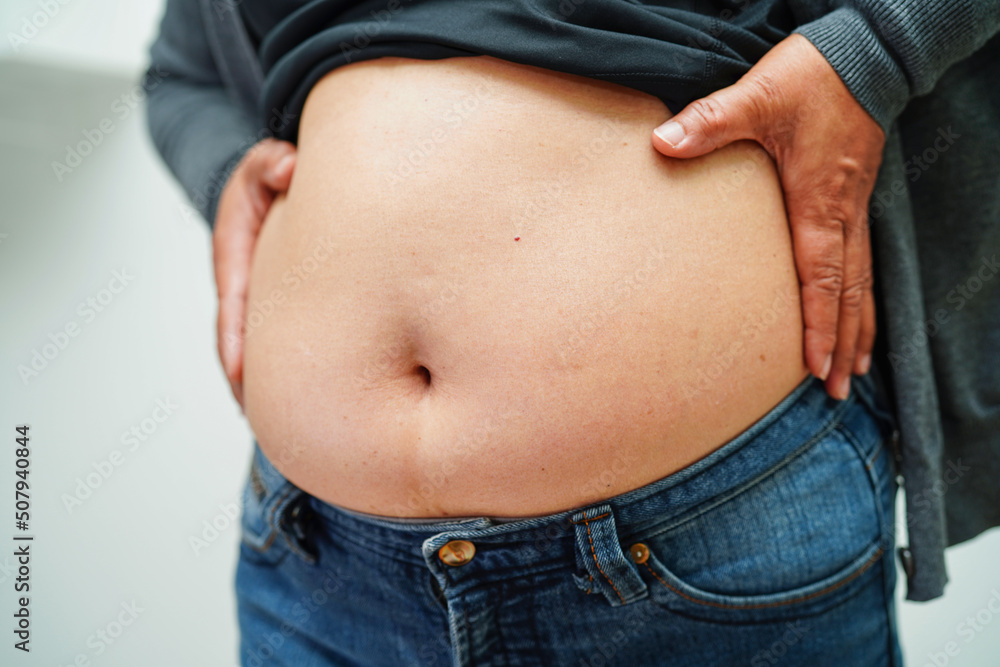 Asian woman show fat belly big size overweight and obesity at office. Asian woman show fat belly big size overweight and obesity at office.