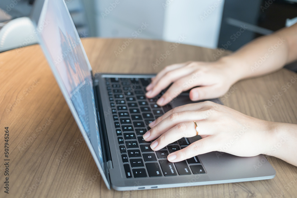 Working from home on laptop while typing chat to customer communicates on internet in home office Working from home on laptop while typing chat to customer communicates on internet in home office