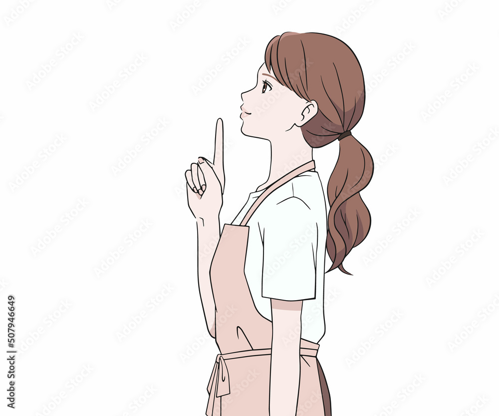 指を差す横を向いたエプロン姿の女性 指を差す横を向いたエプロン姿の女性