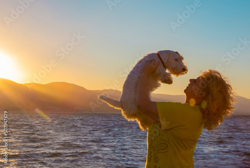 woman and seallyham terrier on the beach photo