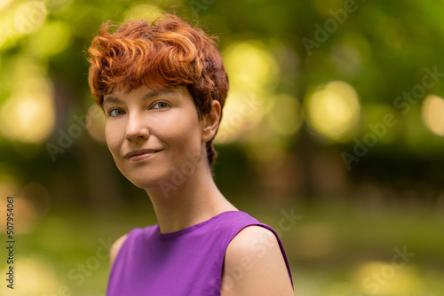 Non-binary gender person looking at camera with relaxed expression photo