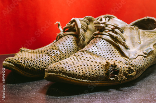 A pair of old yellow leather shoes. Dented men's summer shoes. Close-up. Selective focus.