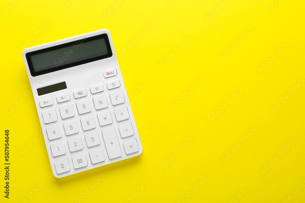Modern calculator on yellow background, top view. Space for text Modern calculator on yellow background, top view. Space for text