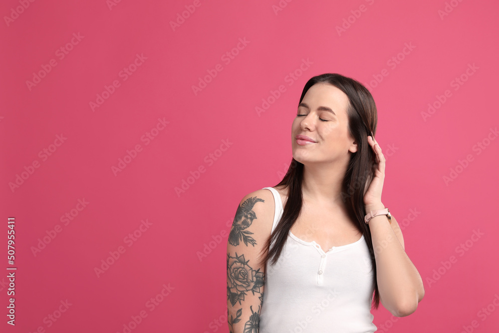 Beautiful woman with tattoos on arm against pink background. Space for text Beautiful woman with tattoos on arm against pink background. Space for text