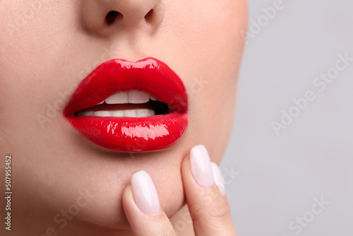 Young woman with perfect lips makeup on light background  closeup