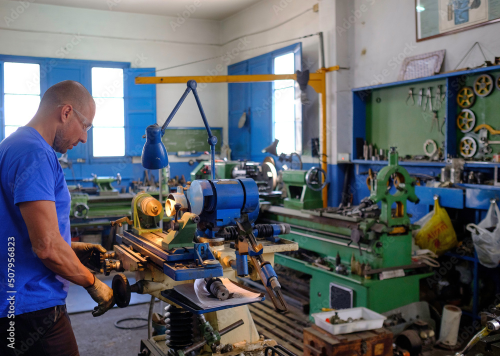 worker working with universal grinding machine.
worker working with universal grinding machine.