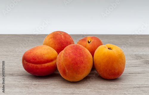 Fresh apricots isolated on wooden table.