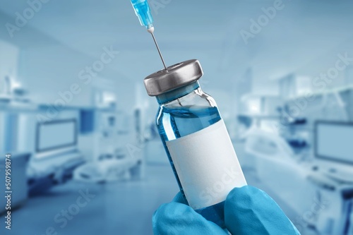 Medical hand holds vaccination for booster Doctor with vial of the doses vaccine. Vaccination and health care concept photo