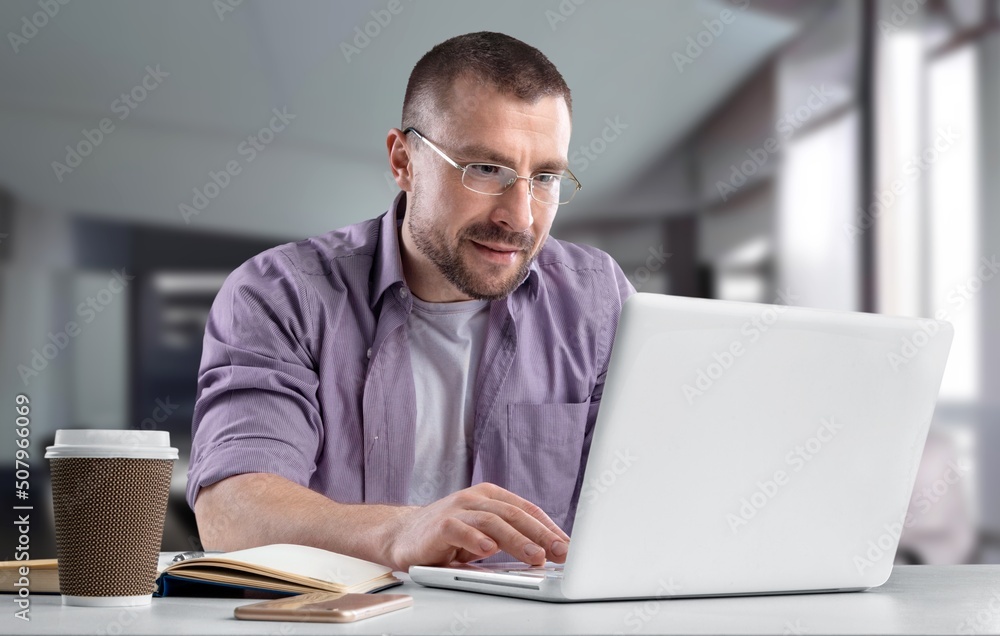 American Businessman Drinking Coffee Using Laptop Computer Sitting During Break American Businessman Drinking Coffee Using Laptop Computer Sitting During Break