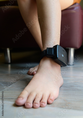 Prisoner is attached to an electronic monitoring on ankle photo