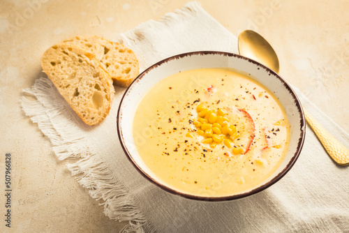 Delicious creamy chilli cheese corn soup served with bread photo
