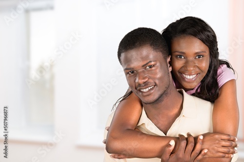 Portrait Of Happy Young couple Embracing In Interior, Loving Having Fun Together