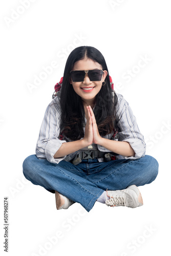 Asian woman with sunglasses and backpack sitting