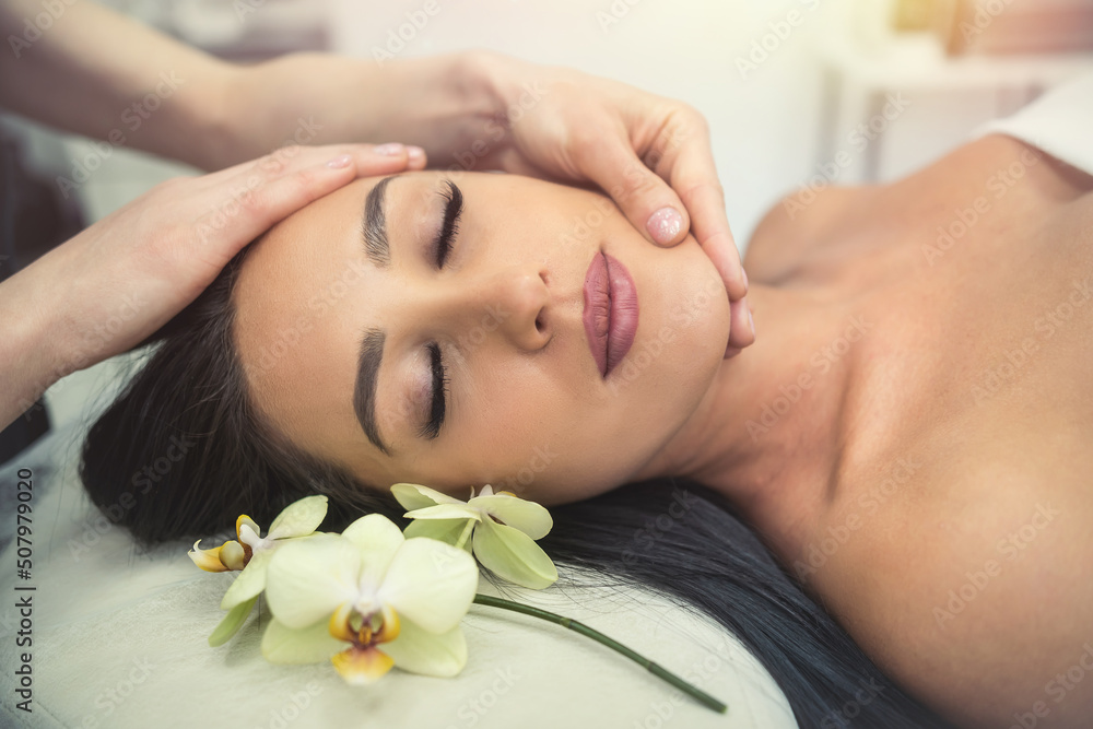 close up of beautician hands doing relaxing rejuvenating massage female client at spa salon close up of beautician hands doing relaxing rejuvenating massage female client at spa salon
