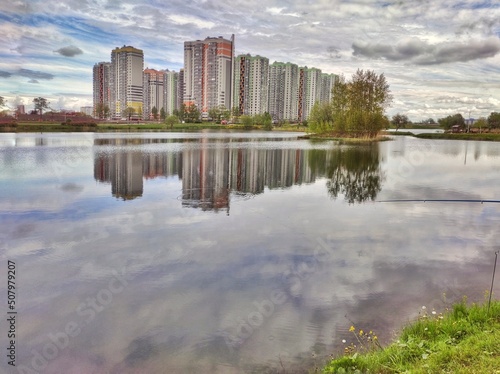 buildings with reflection in the water, cityscape with park