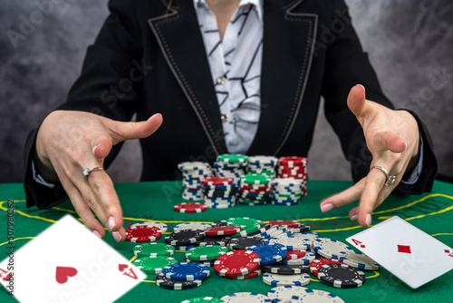  young woman wear black suit playing poker in casino