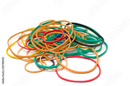 Many colorful rubber rings against a white background