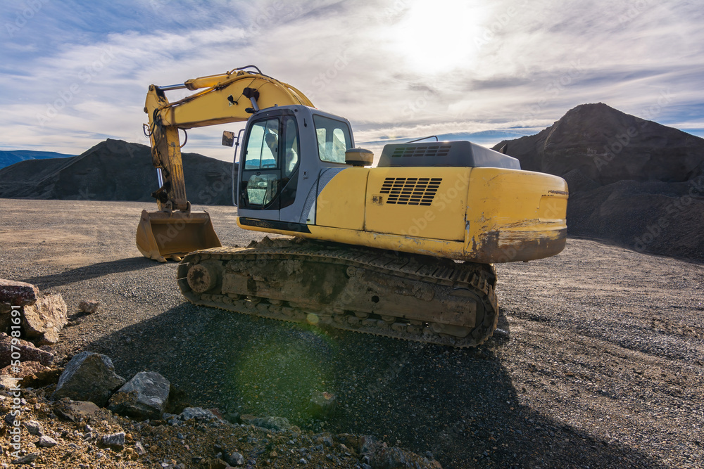 Excavator building a road in a site construction Excavator building a road in a site construction
