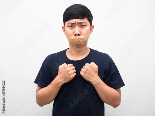 Man afraid with tape close mouth for quiet and don,t speech photo