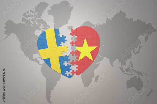 puzzle heart with the national flag of sweden and vietnam on a world map background. Concept.