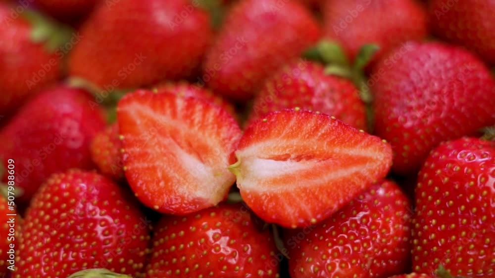 Juicy Ripe Strawberries with Sliced Strawberries Top View, Closeup. Rotation of Red Strawberries. Isolated Background from Strawberries. Healthy Vegan Food and Diet. Juicy Ripe Strawberries with Sliced Strawberries Top View, Closeup. Rotation of Red Strawberries. Isolated Background from Strawberries. Healthy Vegan Food and Diet.