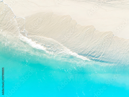 Fototapeta Naklejka Na Ścianę i Meble -  Aerial view of Sand on the beach with a  blue sea wave background