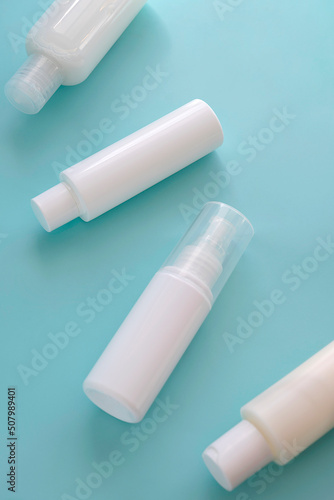 Set of white cosmetic products on pastel blue background. Abstract skin care beauty cosmetics. Top view.