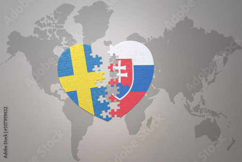 puzzle heart with the national flag of sweden and slovakia on a world map background. Concept.