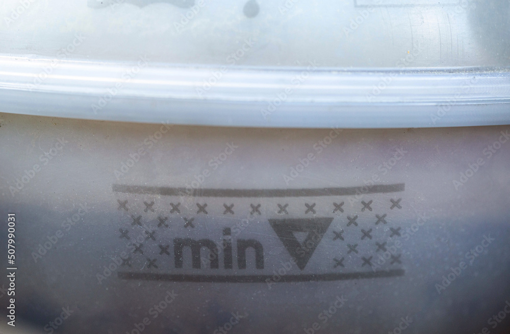 Coolant level in the expansion tank minimum and maximum, closeup