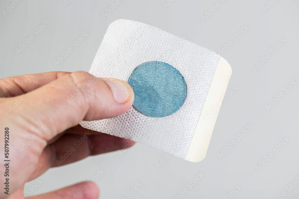 A modern medical patch for prostatitis in a man's hand. Treatment of ...