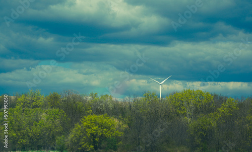 wind turbine. blue background with clouds. photo during the day.