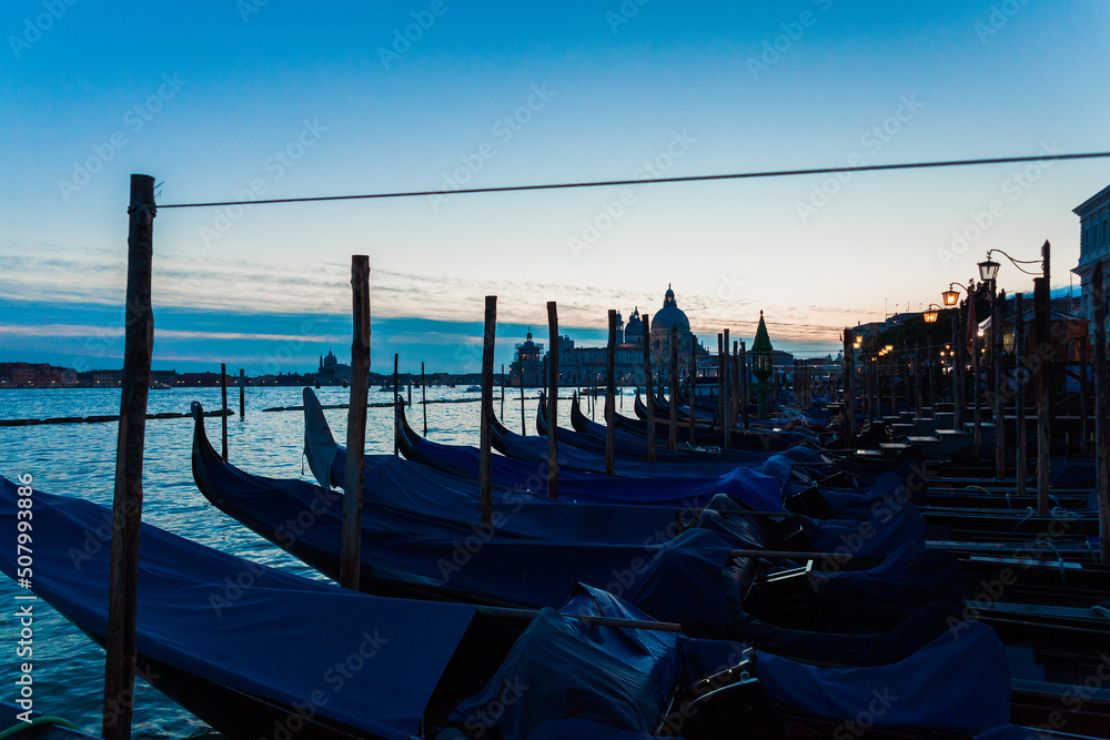 Gondolas at pier in Canal Grande at dusk