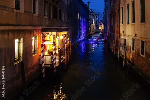 Police boat in dark channel in Venice, Italy. © Jesus Ce