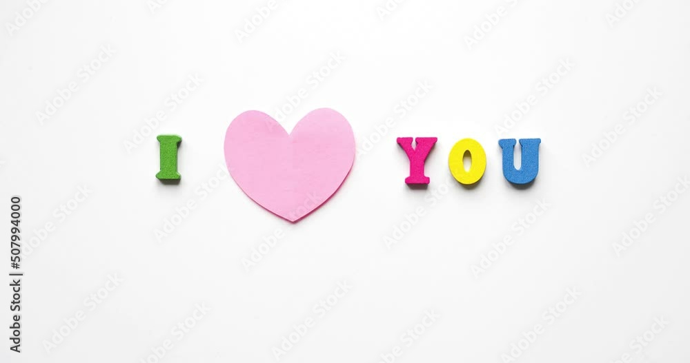 Phrase I Love You from colorful wooden letters with a beating pink heart on a white background. Looped 4K stop motion animation Phrase I Love You from colorful wooden letters with a beating pink heart on a white background. Looped 4K stop motion animation