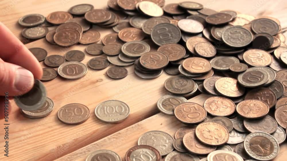 Man's hands money count. Scattering of metal Russian coins of small denominations Man's hands money count. Scattering of metal Russian coins of small denominations
