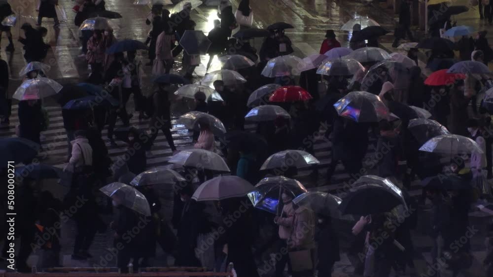SHIBUYA, TOKYO, JAPAN - 6 JAN 2022 : Winter snow scenery around Shibuya crossing and station at night. Crowd of people at the street. Japanese winter season and Christmas concept. Slow motion video. SHIBUYA, TOKYO, JAPAN - 6 JAN 2022 : Winter snow scenery around Shibuya crossing and station at night. Crowd of people at the street. Japanese winter season and Christmas concept. Slow motion video.