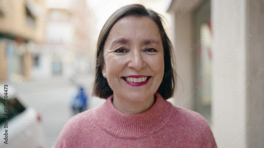 Middle age woman smiling confident standing at street Middle age woman smiling confident standing at street