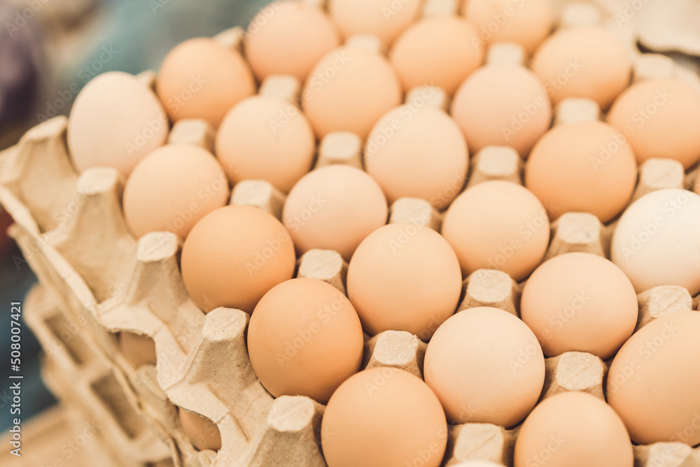 Organic farmer chicken eggs in cardboard egg box at market stall. Egg tray as background with copy space Organic farmer chicken eggs in cardboard egg box at market stall. Egg tray as background with copy space