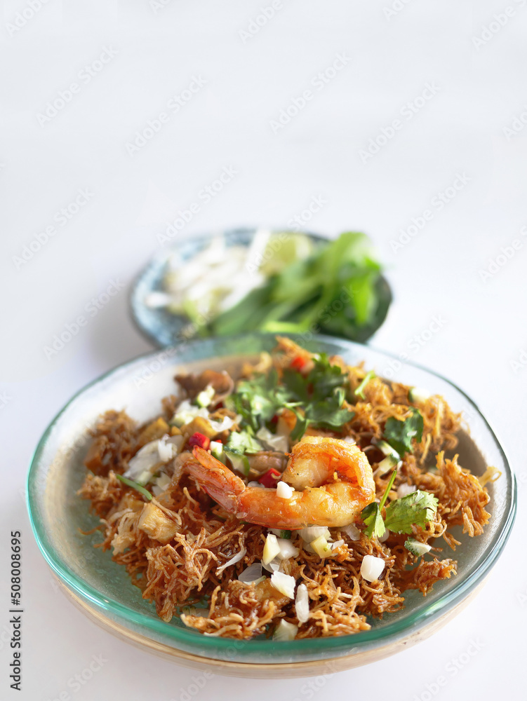 Thai Crispy rice noodles in traditional style with prawn, Royal recipe, in special plate with copy space and white background