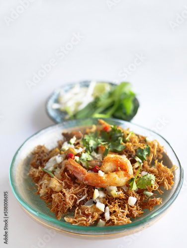 Thai Crispy rice noodles in traditional style with prawn, Royal recipe, in special plate with copy space and white background