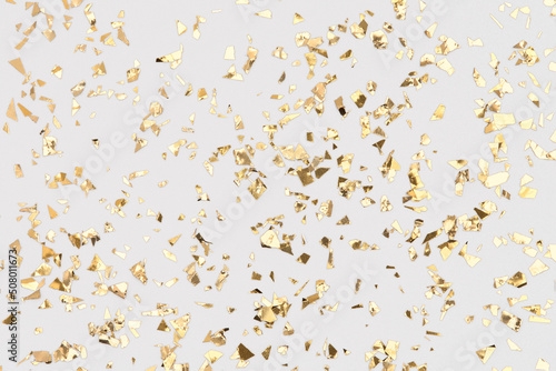 Golden confetti on white background, falling gold foil, festive backdrop for party.